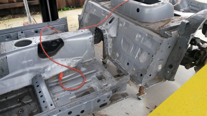 One freshly split Miata chassis.